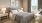 a bedroom with a bed and lamps