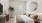 bedroom with bed, round mirror and a plant