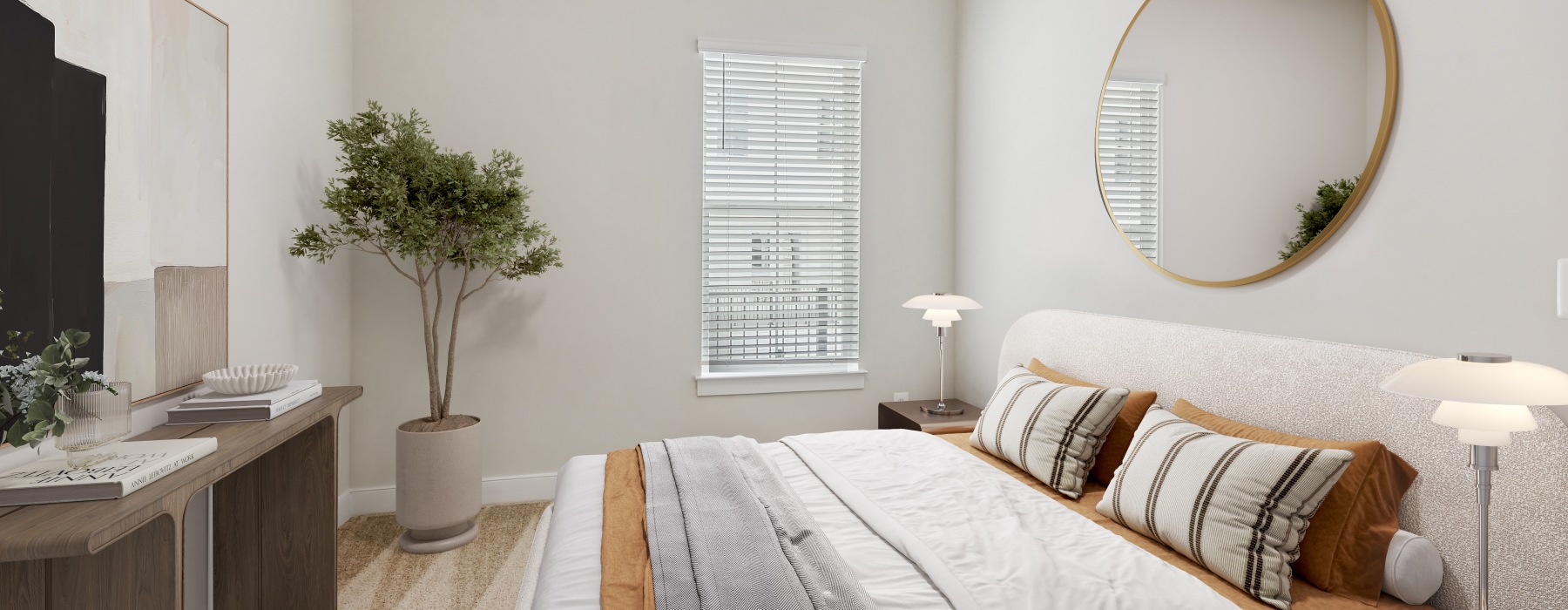 bedroom with bed, round mirror and a plant